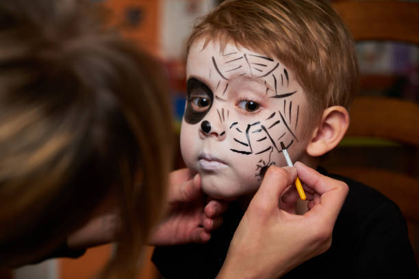 istock Mother is helping son with Halloween makeup 1279311674