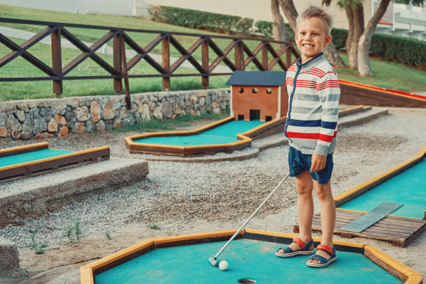 istock Cheerful boy playing mini golf on the territory of the hotel 1279312150