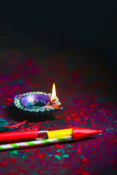 Photo of Concept of Indian festival Diwali, oil lamp or Diya with crackers