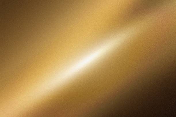 istock Light shining down on dark gold foil metal wall with copy space, abstract texture background 1279312325