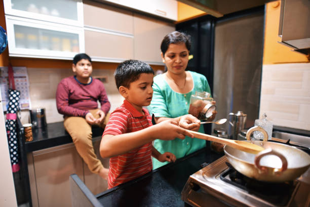istock Brothers helping their mother in kitchen 1279313511