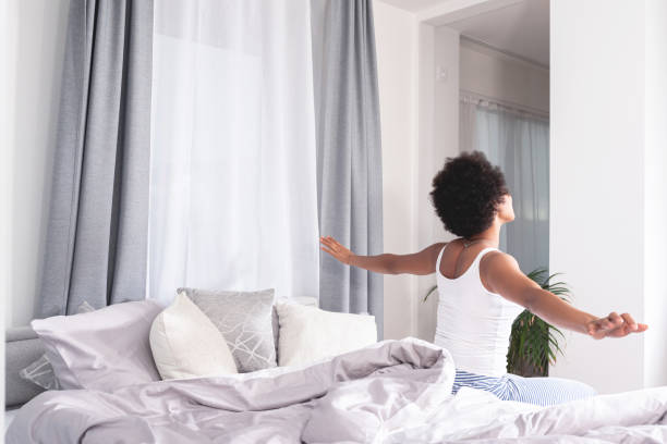 istock Woman stretching after waking up on bed 1279314652