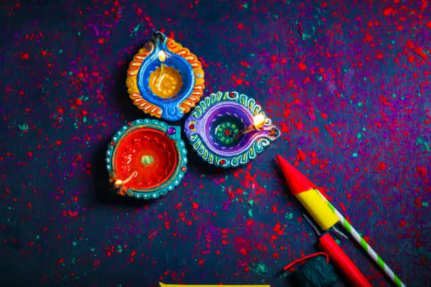 Photo of Concept of Indian festival Diwali, oil lamp or Diya with crackers