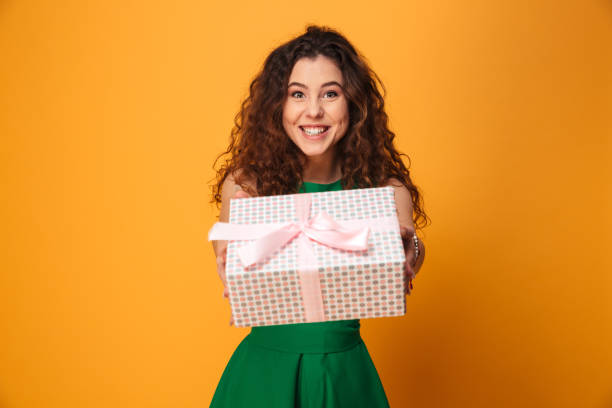istock Cute young woman holding present gift box. 1279315463
