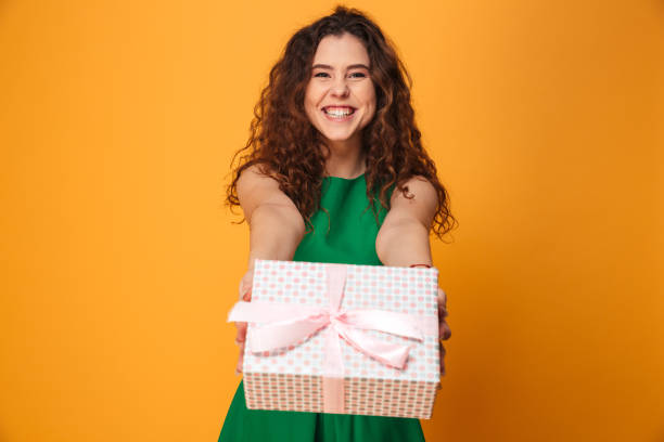 istock Cute young woman holding present gift box. 1279315533