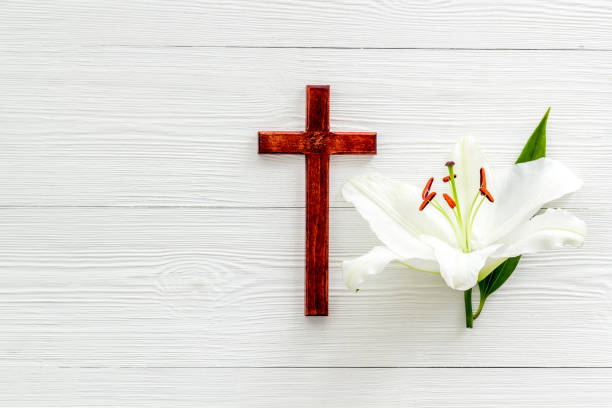 istock Lily funeral flower with cross. Condolence card with copy space 1279318199