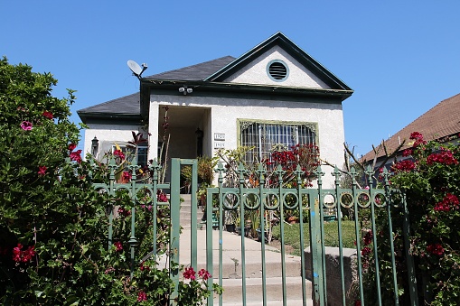 Generic house seen from public street in Boyle Heights district, Los Angeles. Real estate rates in California have grown 105 percent since 1990.