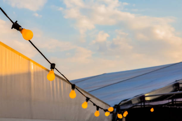 istock Light bulbs on a string hanging outside at party event 1279319545