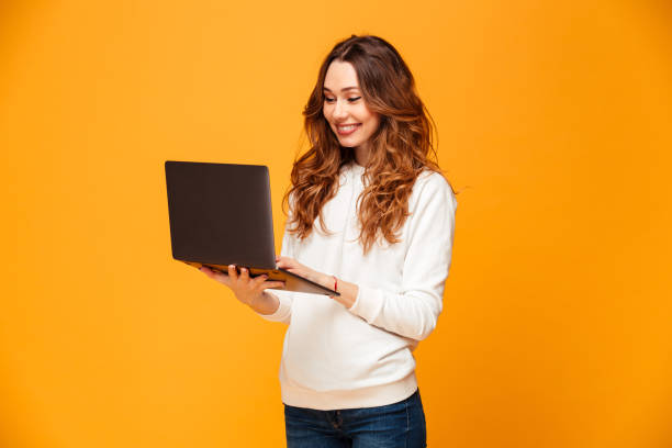 istock Image of Smiling brunette woman in sweater using laptop computer 1279322161