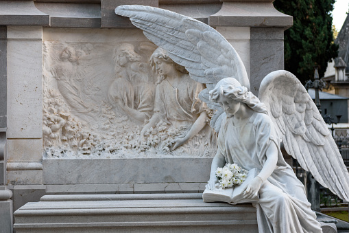 Sculpture of a Guardian Angel taking custody the grave of Herrera family, at Granada's Cemetery. It was made by José Navas-Parejo Pérez in 1921.