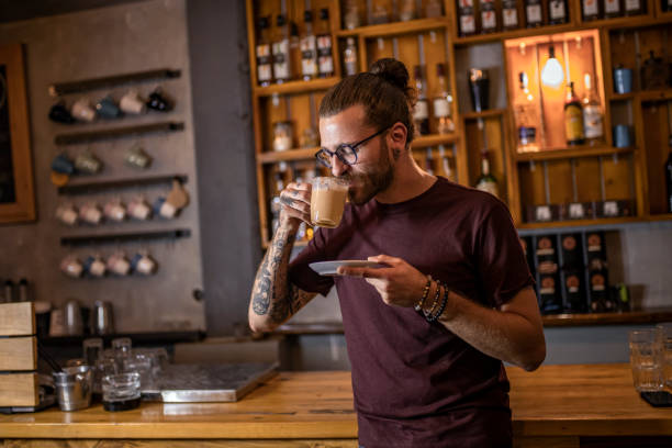 istock Portrait of handsome man drinking coffee at bar 1279323862