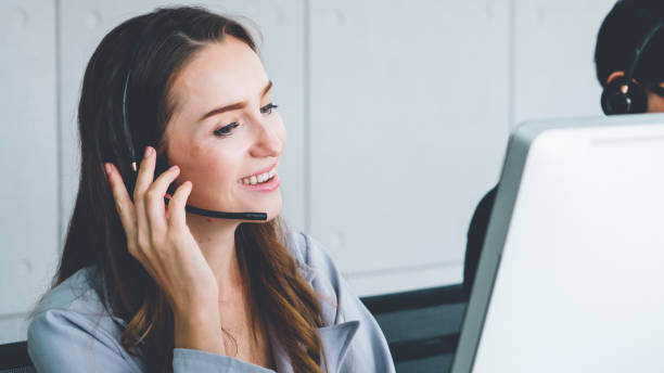 istock Business people wearing headset working in office 1279325131