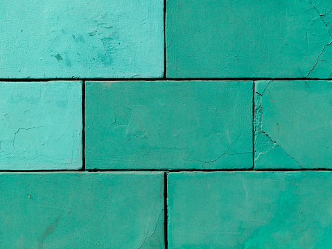Brick wall is painted mint green color. stone background