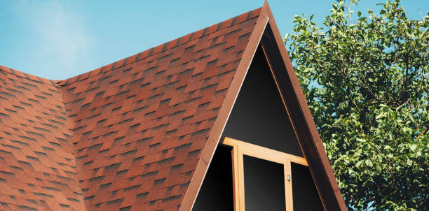 A brown modern house roof near a tree