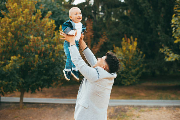 istock A happy man is holding his baby in park 1279328081