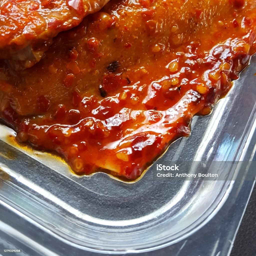 Mackerel in sweet chilli sauce Mackerel in sweet chilli sauce in plastic packaging close up Plastic Container Stock Photo