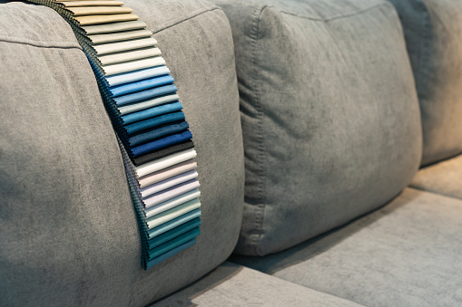 Black cushions with  stripes on a gray sofa