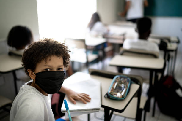 istock Portrait of a schoolboy studying in the classroom using face mask 1279329978