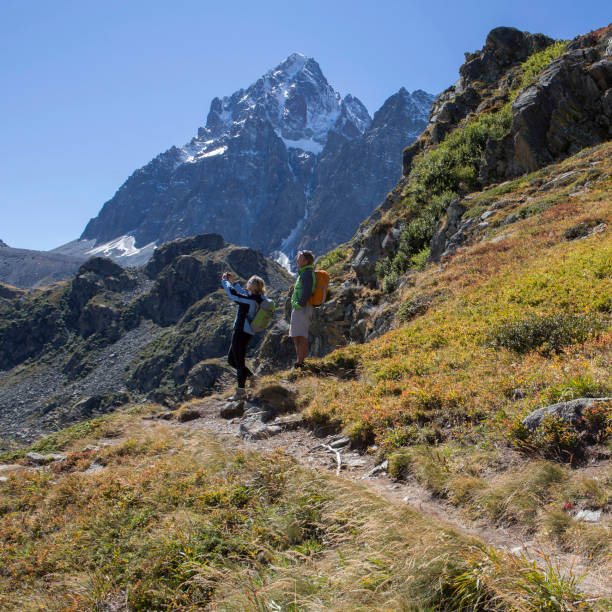 istock Hiking couple take pic from alpine path 1279331235