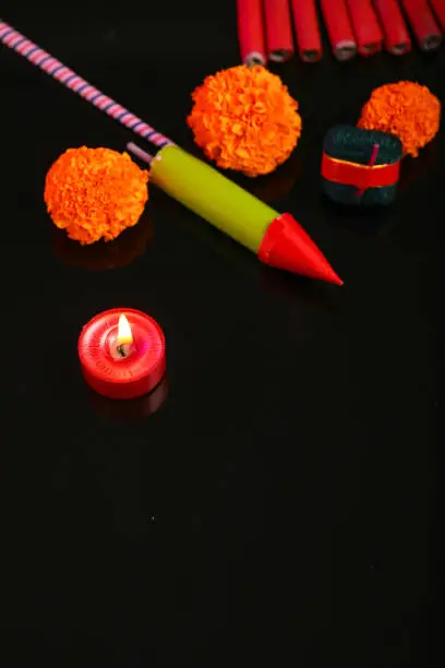 Photo of Indian festival Diwali, candle with crackers over dark background