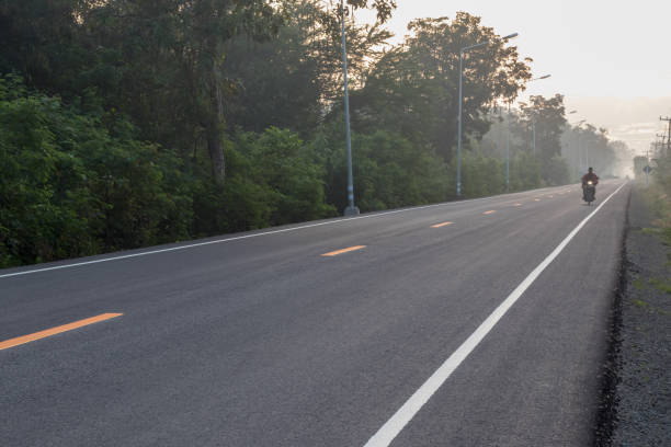 istock Asphalt road with sun rising in the countryside. 1279332287