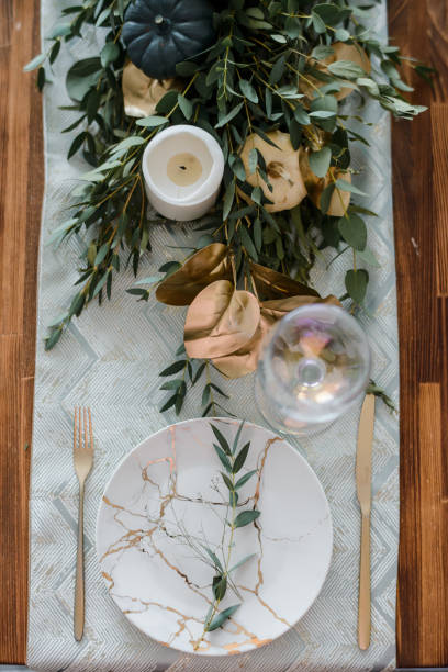 istock Halloween Table setting on dark background. Dish with sweets s on a dark table with black and gold pumpkin. Flat lay, top view trendy holiday concept. 1279332696