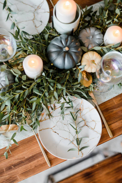 istock Halloween Table setting on dark background. Dish with sweets s on a dark table with black and gold pumpkin. Flat lay, top view trendy holiday concept. 1279332741