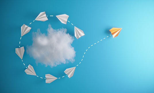 Group of paper airplane orbiting around an abstract cloud and with one individual pointing in the different way, can be used innovation/leadership/individuality concepts.( 3d render )