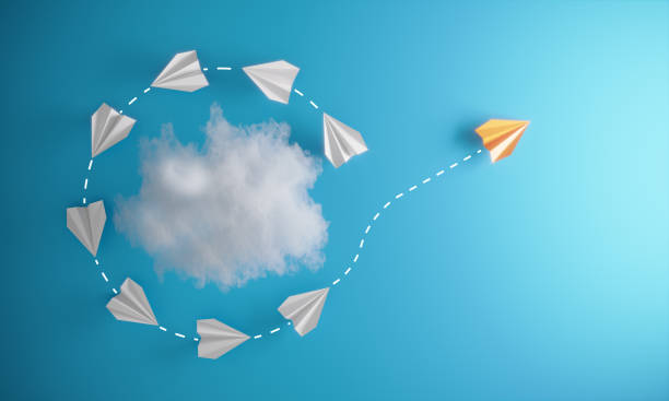 Different Approach - Different Direction Group of paper airplane orbiting around an abstract cloud and with one individual pointing in the different way, can be used innovation/leadership/individuality concepts.( 3d render ) innovation individuality standing out from the crowd contrasts stock pictures, royalty-free photos & images