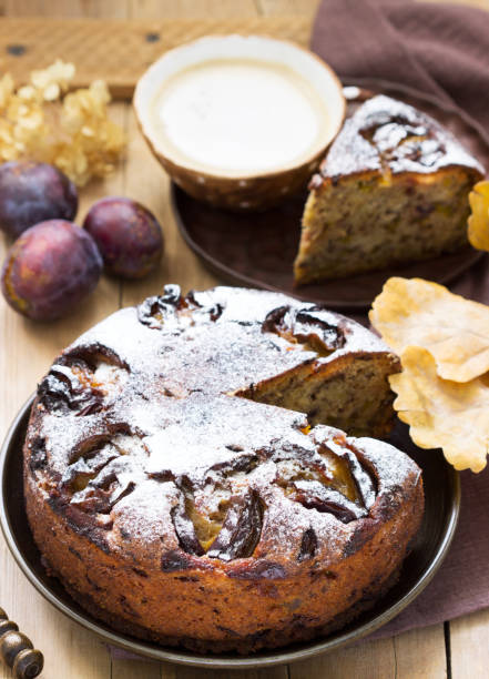 istock Plum pie with nuts and chocolate on a wooden background. Rustic style. 1279333906