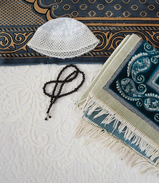 istock Worship tools and materials, prayer rug, prayer beads and skullcap in islam, 1279334929