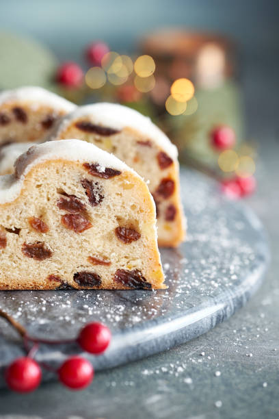 istock Christmas stollen on white-blue festive background with berries and Xmas lights 1279335425