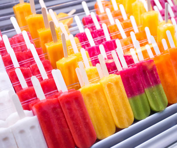 close up of colorful popsicles on market stall stock photo