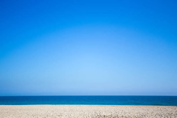 istock summer and travel concept - beach with white sand and blue sky 1279337385