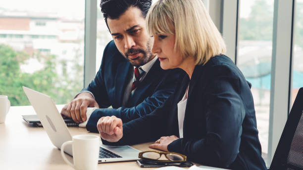 istock Two business people talk project strategy at office 1279337744