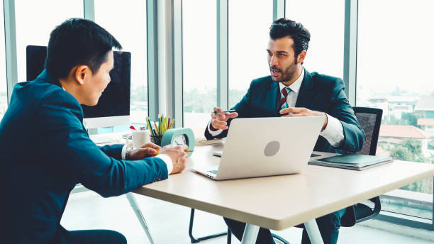 istock Two business people talk project strategy at office 1279338016