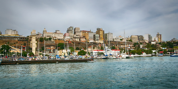 Salvador, Bahia, Brazil - 2009: iconic pier of the city, with a lot of typical leisure and fishing boats peacefully at the sea.