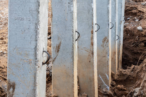 istock Close-concrete pillars installed in a trench dug soil. 1279339122