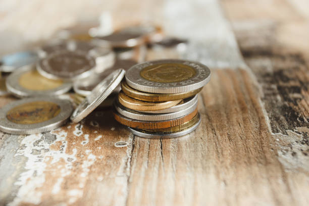istock Gold, silver coins on the wooden background 1279340025