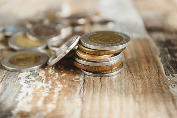 istock Gold, silver coins on the wooden background 1279340208