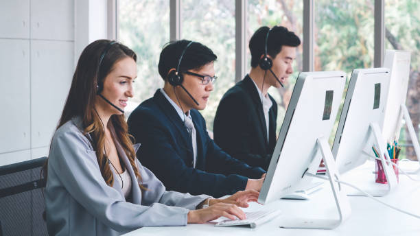 istock Business people wearing headset working in office 1279340529