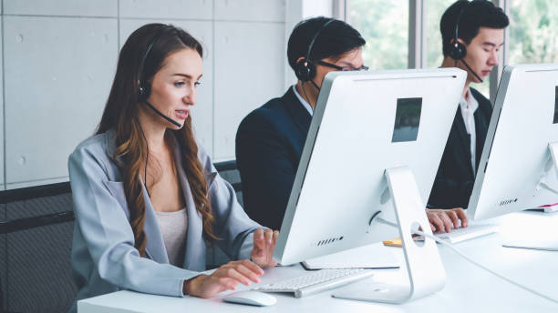 istock Business people wearing headset working in office 1279341548