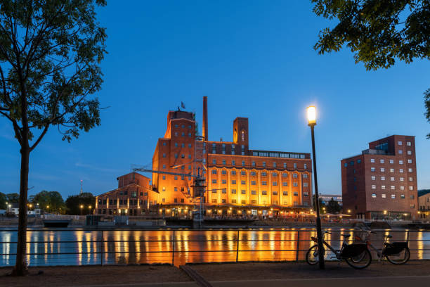 illuminated buildings at inner Harbour river side in Duisburg at blue hour