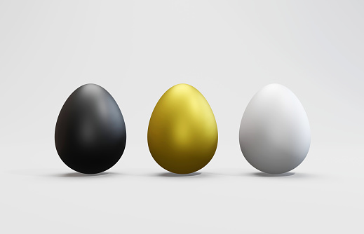 Black, Gold and White eggs on White Background. Investment and finance concept. Horizontal composition with copy space.