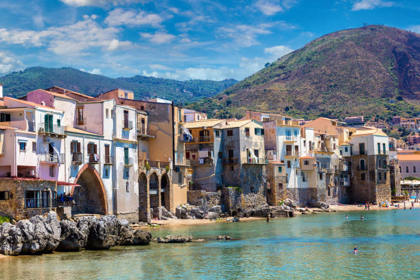 Sandy beach in Cefalu in Sicily Harbor and old houses in Cefalu in Sicily, Italy in a beautiful summer day cefalu stock pictures, royalty-free photos & images