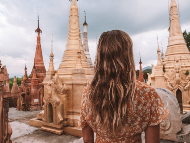 istock Woman contemplates ancient temple in Myanmar 1279344400