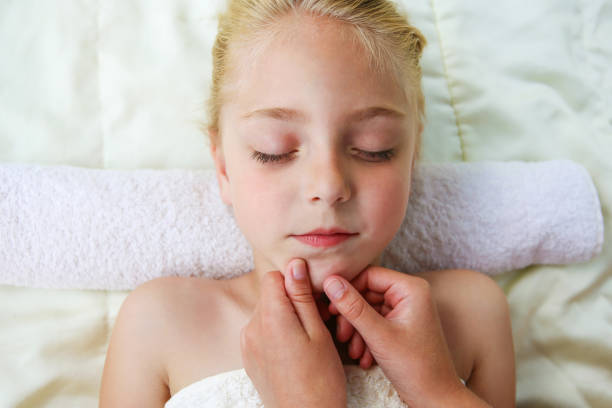 istock Masseur doing face massage to child. 1279344530