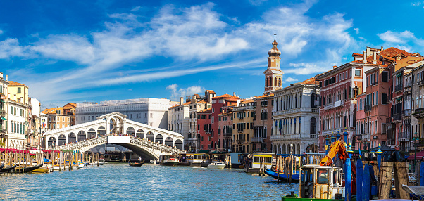Gondola at the Rialto bridge in Venice, in a beautiful summer day in Italy
