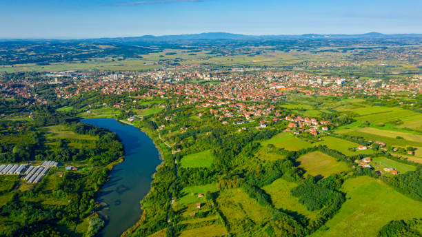 istock Green hilly landscape and small town 1279346108