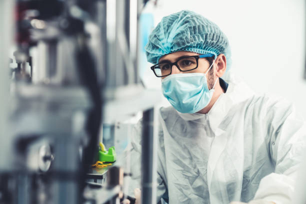 istock Production line worker with face mask working in electronic factory 1279346132
